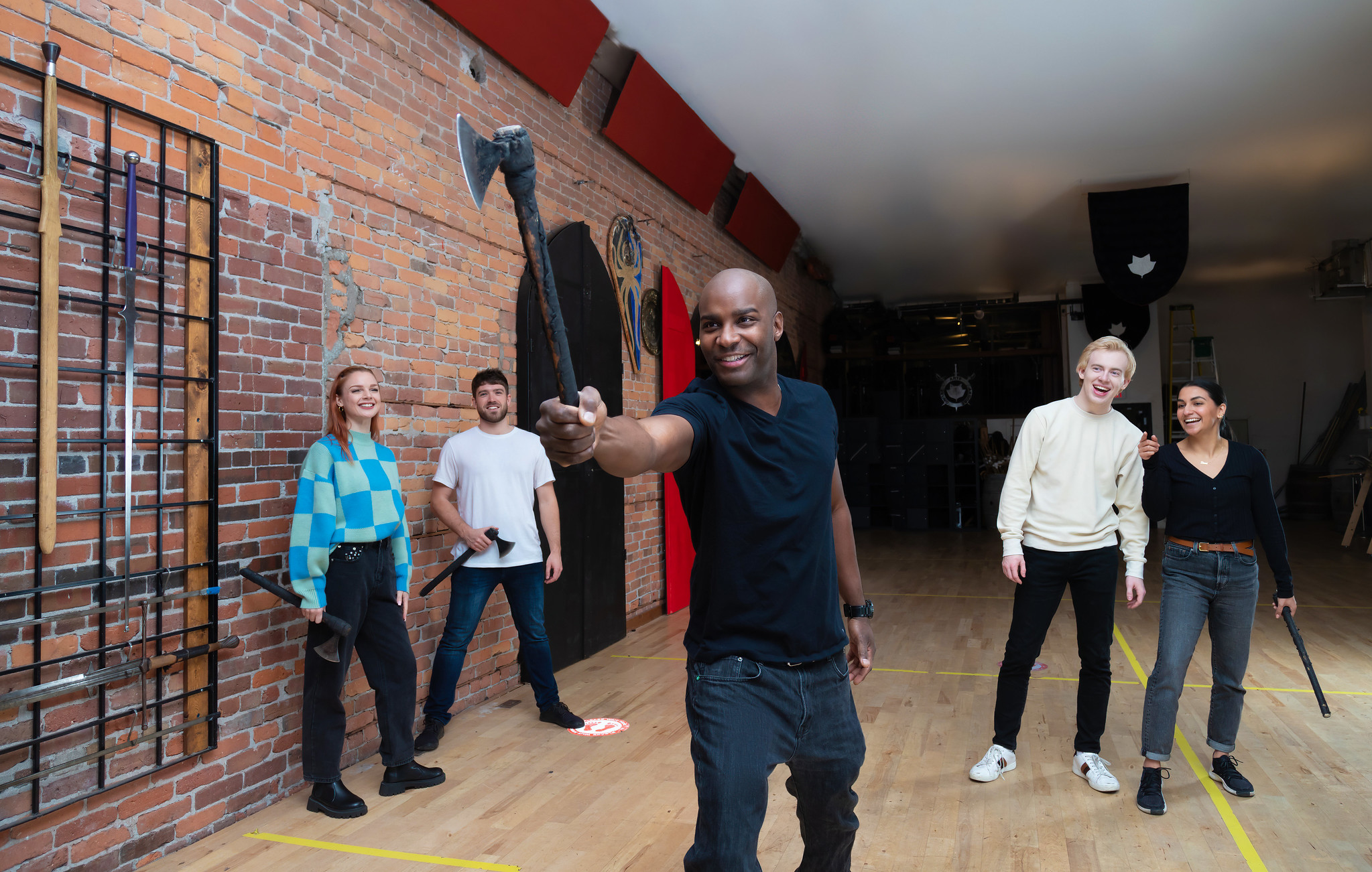 Axe thrower mid-throw at Academie Duello