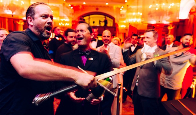 Party-goers sabering champagne