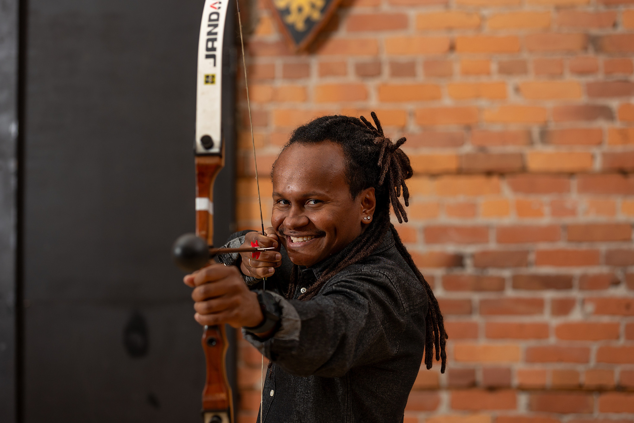 Student learning proper archery form